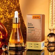 Bosin peptide serum bottle and box on a decorative background, promoting skin rejuvenation and hydration.