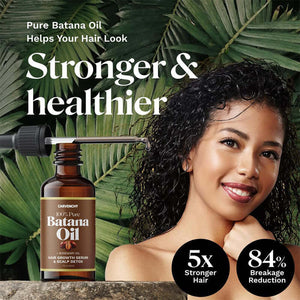 Woman with curly hair holding a bottle of Pure Batana Oil, promoting stronger and healthier hair.